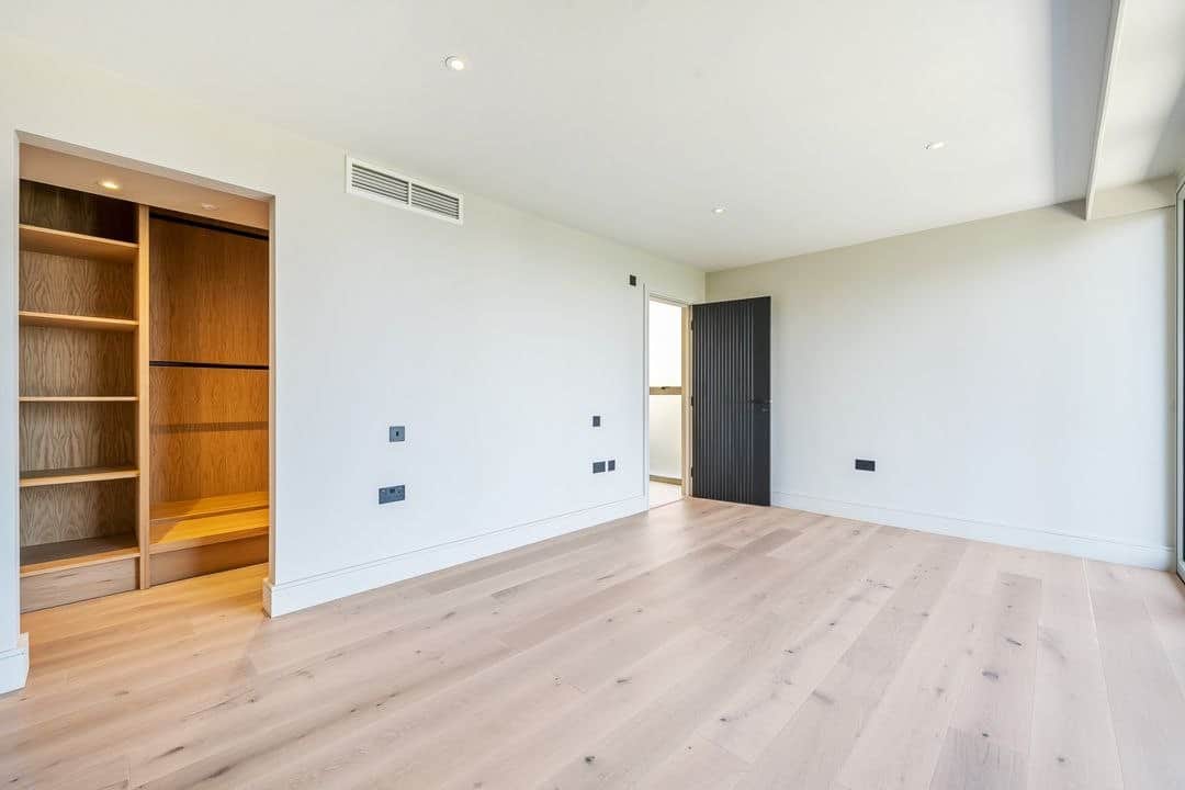 Fitted wardrobe and pale timber floor in a premium Cornwall bedroom